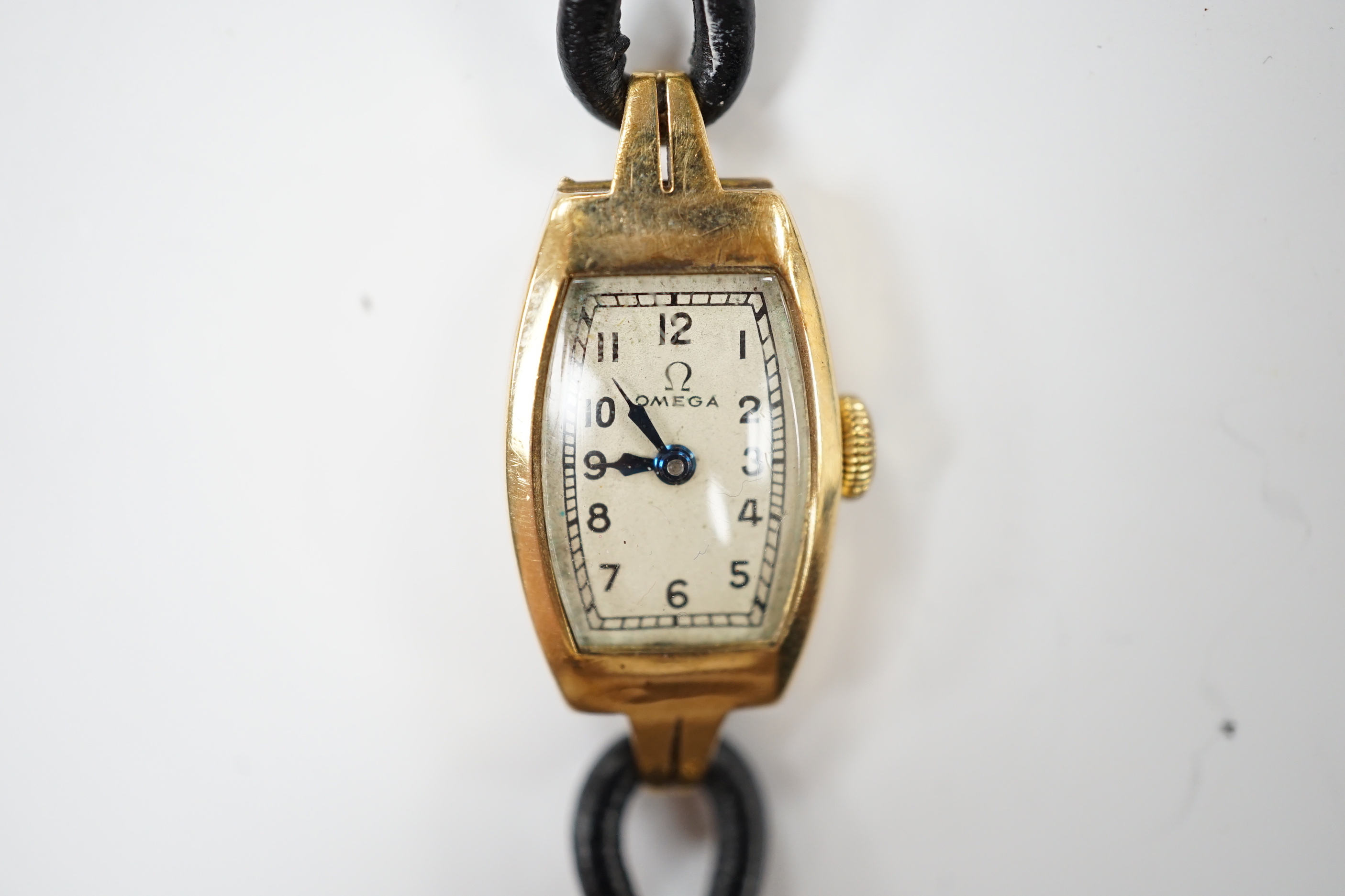 A lady’s 9ct gold Omega manual wind wrist watch, on a twin fabric strap.